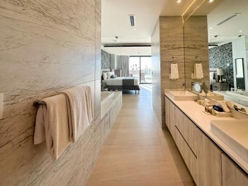 a bathroom with two sinks and a large mirror at Brand New 3BR Ground Floor Pool Walkout at Las Palomas in Puerto Peñasco