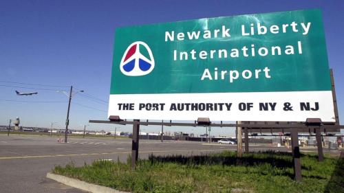 a sign for the newark library international airport at Modern one bedroom apartment in Elizabeth