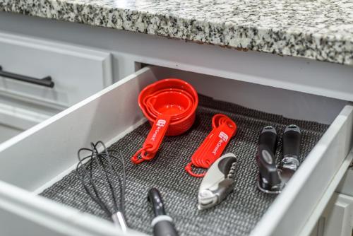 a drawer withrenches and other kitchen utensils in it at 3BR Cozy Home~ Stylish & New ~ UC Merced ~ en route Yosemite! in Merced