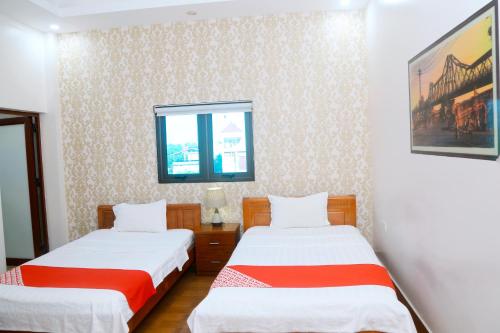 a room with two beds and a window at Luxury Airport Hotel & Travel in Noi Bai