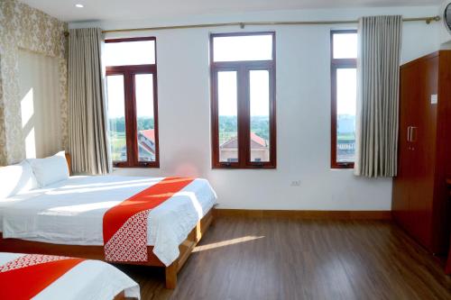 a hotel room with two beds and windows at Luxury Airport Hotel & Travel in Noi Bai