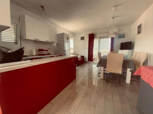 a kitchen and living room with a table and chairs at Apartments by the sea Necujam, Solta - 21950 in Grohote