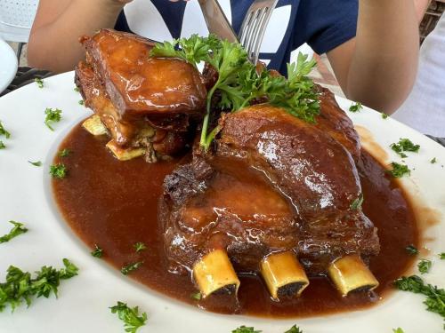 a plate of food with meat and sauce on a table at Hotel campestre la Maria in Villavicencio