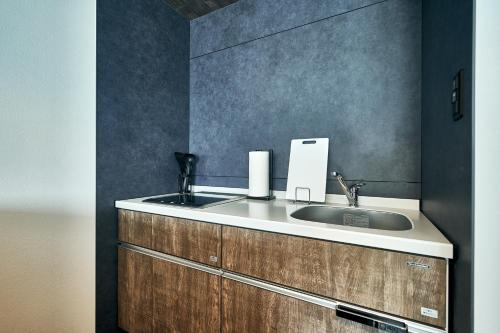 a bathroom with a sink and a counter at Grand STAY 博多駅北 in Hakata