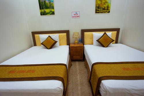 Кровать или кровати в номере Minh Cường Hotel