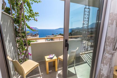 a balcony with a view of the ocean at Defne Hotel in Kas