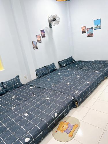 a large blue bed with a teddy bear on it at K-HOUSE Homesaty Phan Thiết in Ấp Bình Hưng