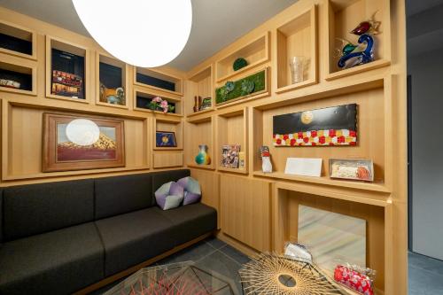 a living room with a couch and a fireplace at RESI STAY Mayu Grace Hotel in Kyoto