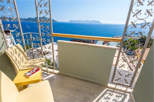 a balcony with a view of the ocean at Defne Hotel in Kas