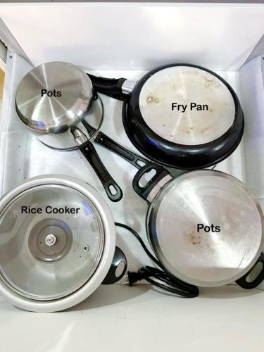 a group of pots and pans sitting on a counter at Acqua Private Residence Livingstone Tower Condo Unit with Free Wifi in Manila