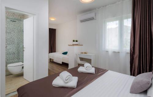 - une chambre avec un lit et 2 serviettes dans l'établissement 4 Bedroom Amazing Home In Solin, à Solin