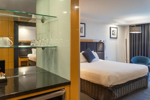 a hotel room with a bed and a glass counter at Adelaide Rockford in Adelaide