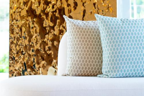 two pillows sitting on top of a bed at Sole Mio Boutique Hotel and Wellness - Adults Only in Bang Tao Beach