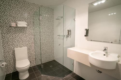 a bathroom with a toilet and a sink and a shower at Adelaide Rockford in Adelaide