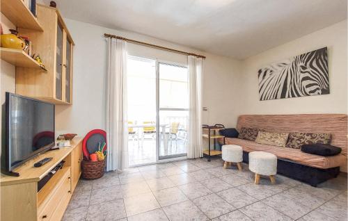 a living room with a couch and a television at 2 Bedroom Nice Apartment In Moncofa in Moncófar