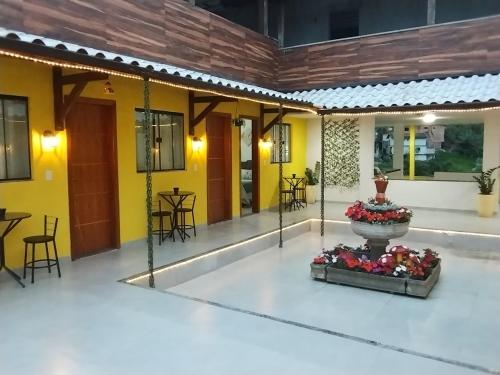a courtyard with a fountain in the middle of a building at Hospedagem Encantos da Serra in Itatiaia