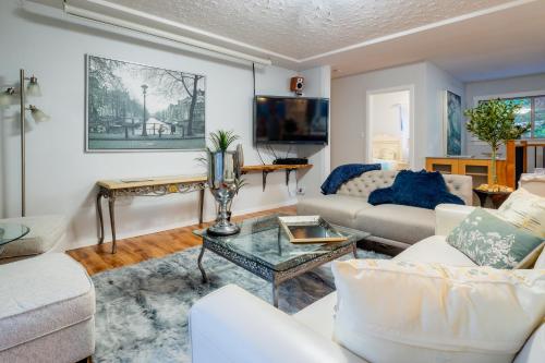 a living room with two couches and a tv at NorthVAN nature living home in North Vancouver
