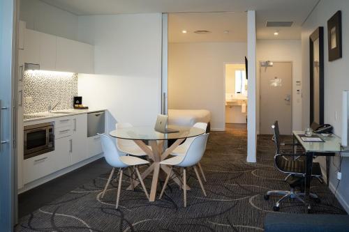 a kitchen and dining room with a table and chairs at Adelaide Rockford in Adelaide