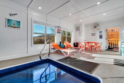 a swimming pool in a room with a table and chairs at The Heritage in Pigeon Forge
