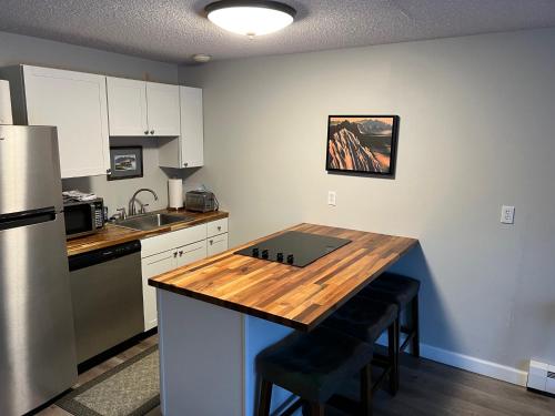 a kitchen with a wooden counter top in a room at The Pioneer Studio at 1400K in Anchorage