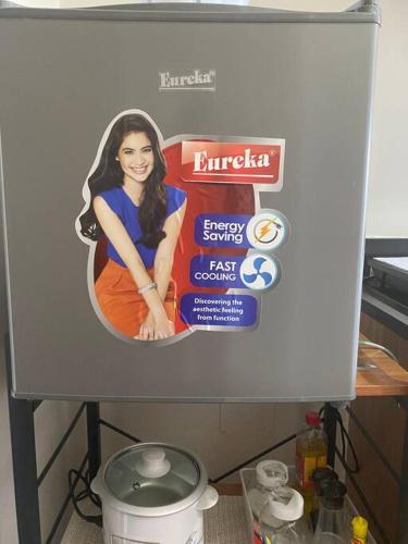 a sign for a kitchen with a picture of a woman at Eve's Condo in Cagayan de Oro