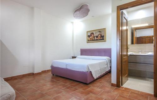 a bedroom with a bed and a bathroom with a tub at Pet Friendly Home In Stella Cilento With House A Panoramic View in Stella Cilento