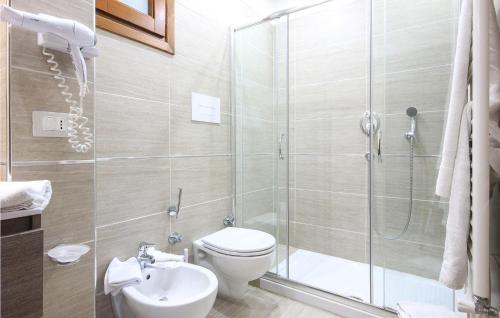 a bathroom with a shower and a toilet and a sink at Pet Friendly Home In Stella Cilento With House A Panoramic View in Stella Cilento