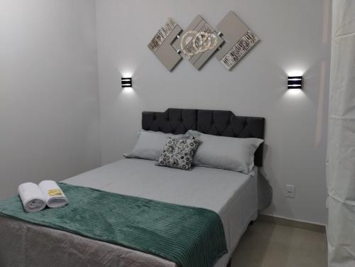 a bedroom with a bed with two towels on it at Hospedagem Encantos da Serra in Itatiaia
