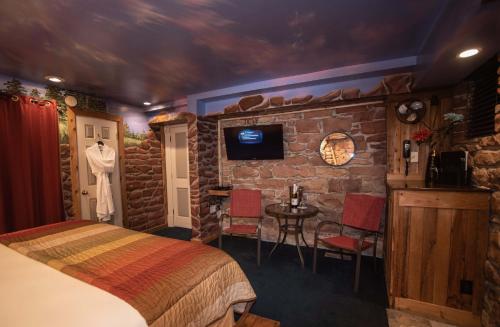 a room with a bed and a stone wall at The Anniversary Inn - South Temple in Salt Lake City