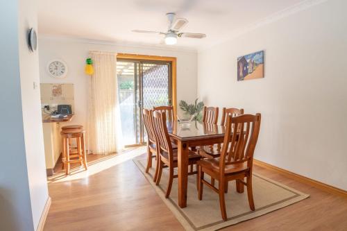 a dining room with a table and chairs at McKinnon on the Bay in East Ballina