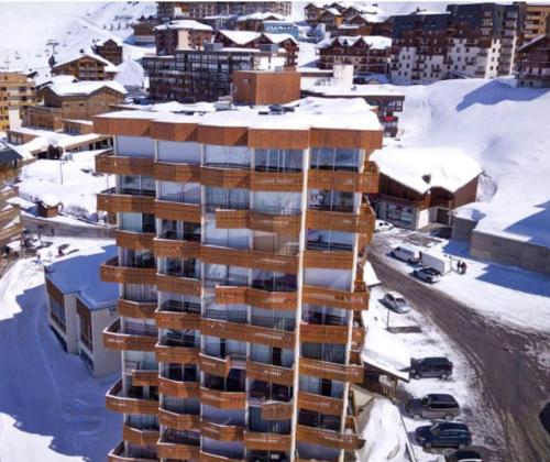 an aerial view of a building in the snow at Dome De Polset Condo by AlpStays in Val Thorens
