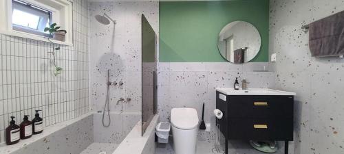 a bathroom with a toilet and a sink and a shower at Hey Day Jeju in Jeju