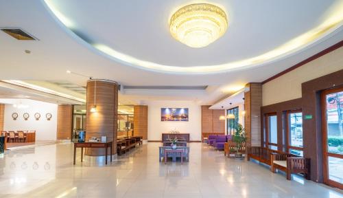 a lobby of a hospital with a large ceiling at The President Hotel at Chokchai 4 in Bangkok