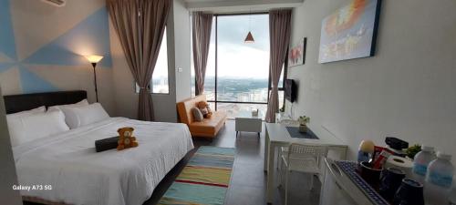 a bedroom with a bed with a teddy bear on it at Maya empire studio in Kampong Bukit Lanjan