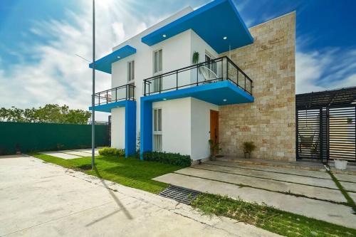 a blue and white house with a balcony at SWEET DREAM VILLA in Punta Cana