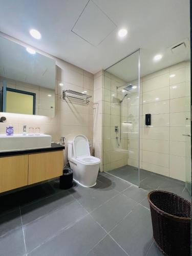 a bathroom with a toilet and a sink and a shower at QUINCE HOME GRAND ION DELEMEN GENTING HIGHLANDs in Genting Highlands