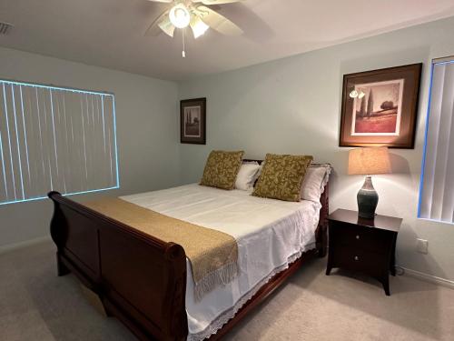 a bedroom with a bed and a ceiling fan at Sin City's Hidden Gems in Las Vegas