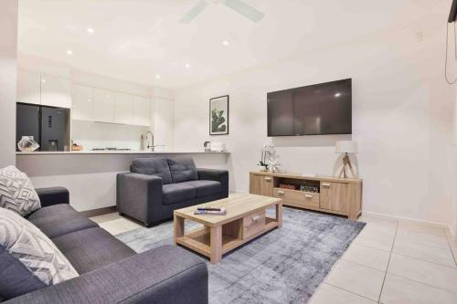 a living room with a couch and a table at Inner City Stay Mildura in Mildura