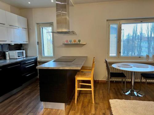 a kitchen with a counter and a table with chairs at Apartment Malmö in Vaasa