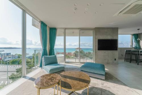 a living room with a view of the ocean at Okinawa Plaisant Villa in Nakadomari