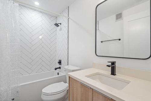 a white bathroom with a toilet and a sink at Capitol View 3 Penthouse with Rooftop in Washington