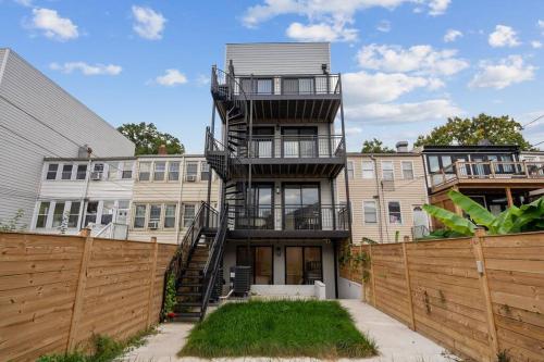 a house with a spiral staircase in front of a fence at Capitol View 3 Penthouse with Rooftop in Washington