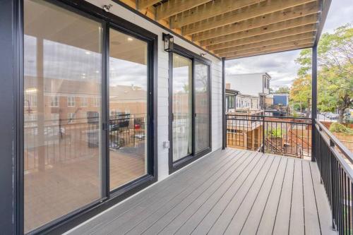 a screened porch with glass doors and a deck with a view at Capitol View 3 Penthouse with Rooftop in Washington