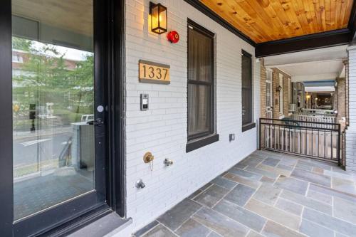 a front porch of a house with a clock on it at Capitol View 3 Penthouse with Rooftop in Washington