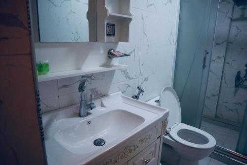 a bathroom with a sink and a toilet at Italian House in Baghdād