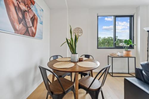 a dining room with a table and chairs at Light Filled 2BR Apt with Balcony, Parking, Cafes & Restaurants in Melbourne