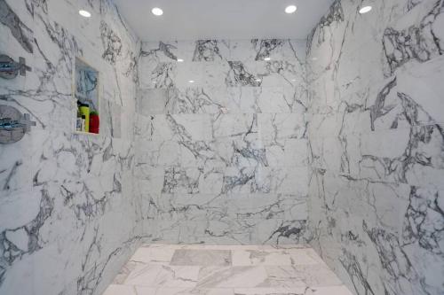 a bathroom with a white marble wall at Central DC Home+Private Rooftop! (Unit B) in Washington, D.C.