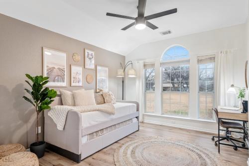 a living room with a white couch and windows at Lake Marble Falls Waterfront, House, Wet Slip, Huge Yard in Marble Falls