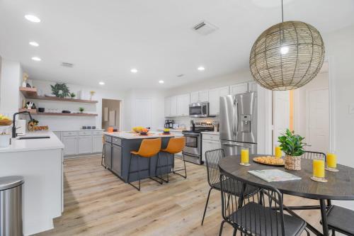a kitchen with white cabinets and a table and chairs at Lake Marble Falls Waterfront, House, Wet Slip, Huge Yard in Marble Falls