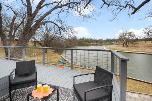 a balcony with two chairs and a table with drinks on it at Lake Marble Falls Waterfront, House, Wet Slip, Huge Yard in Marble Falls